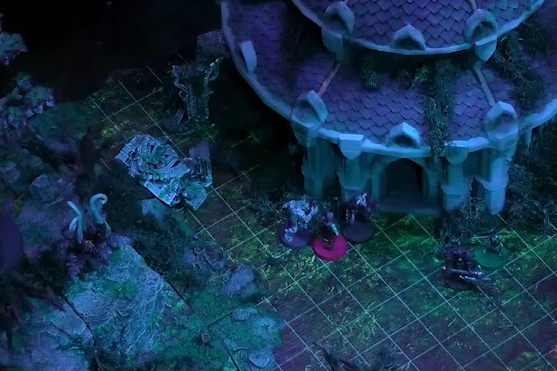 A battlemap focused on the base of a building with a pale purple shingled roof. Ashton, Orym, and wolven Chetney face off against two armored guards.