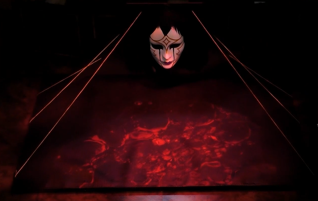 A battlemap depicting a floor of glowing red blood looked over by a patterned porcelain mask with hair of black feathers. Six golden strands run from behind the mask to the edges of the floor.