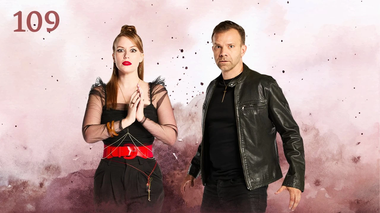 Thumbnail for episode 109. Marisha and Liam pose side-by-side looking wide-eyed at the viewer. Marisha’s hands are together in front of her while Liam stands at an angle, ready to take action. Marisha wears a gauzy black dress with red belt and keys on a string around her waist. Liam wears a leather jacket, black shirt, and sword necklace. They stand against a colorful backdrop with splashes and specks of maroon over white.